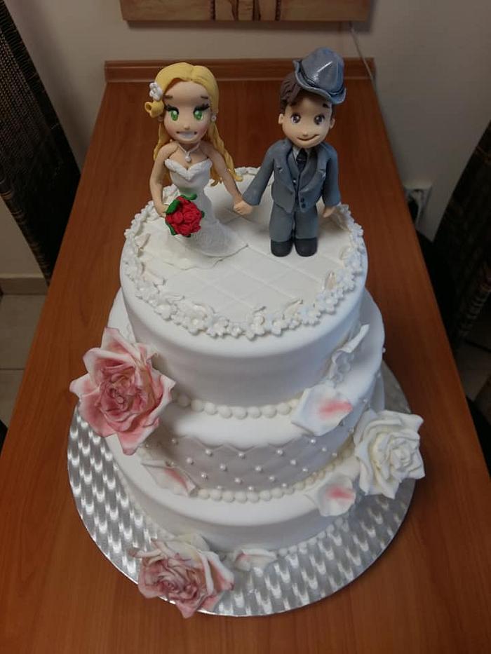 Wedding cake with figures and roses