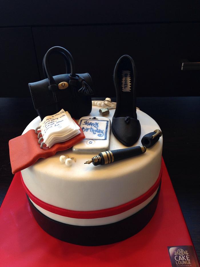 Birthday cake with Mulberry bag Chanel shoe pearl earrings and necklace and an agenda