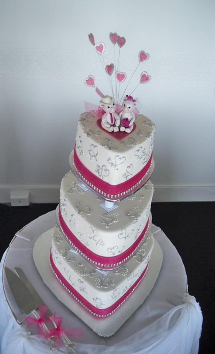 silver hearts and hot pink ribbon with teddy bear cake topper