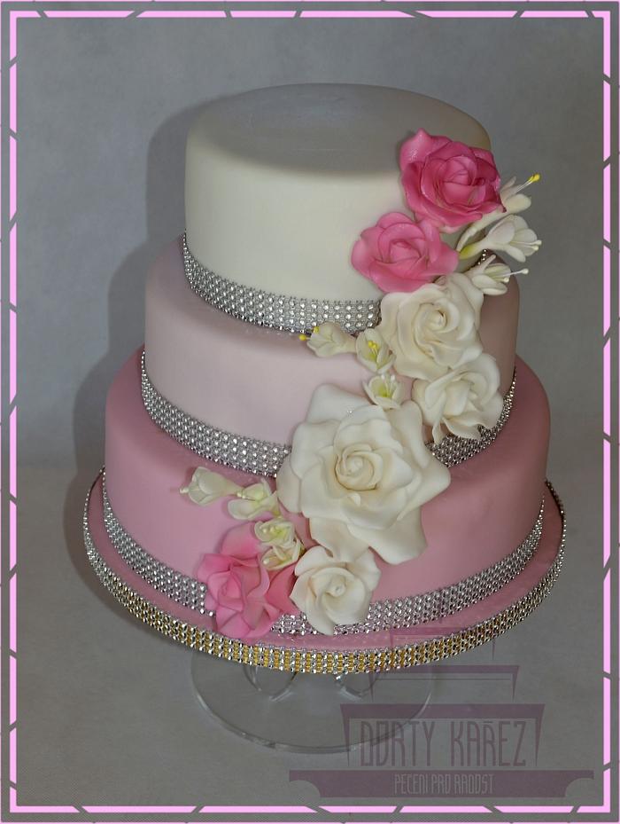 Pink and white wedding cake with roses