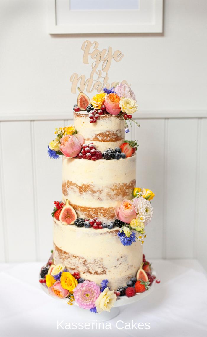 Semi-naked wedding cake with fruit and flowers