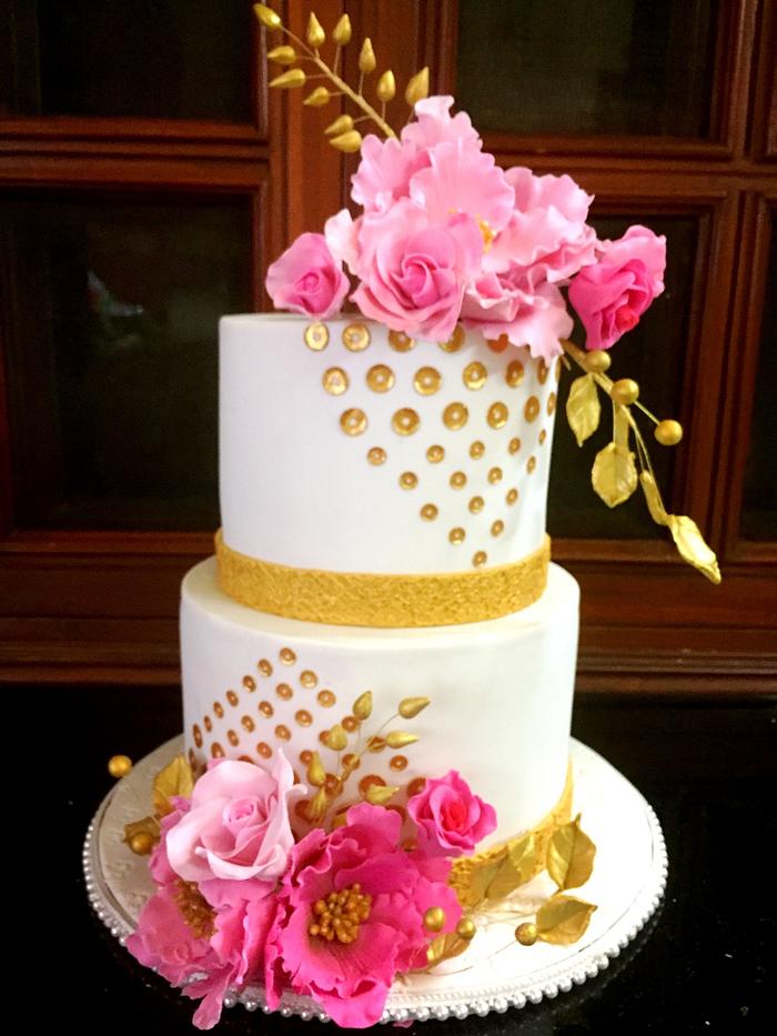 White cake with gold sequins,pink peonies and roses