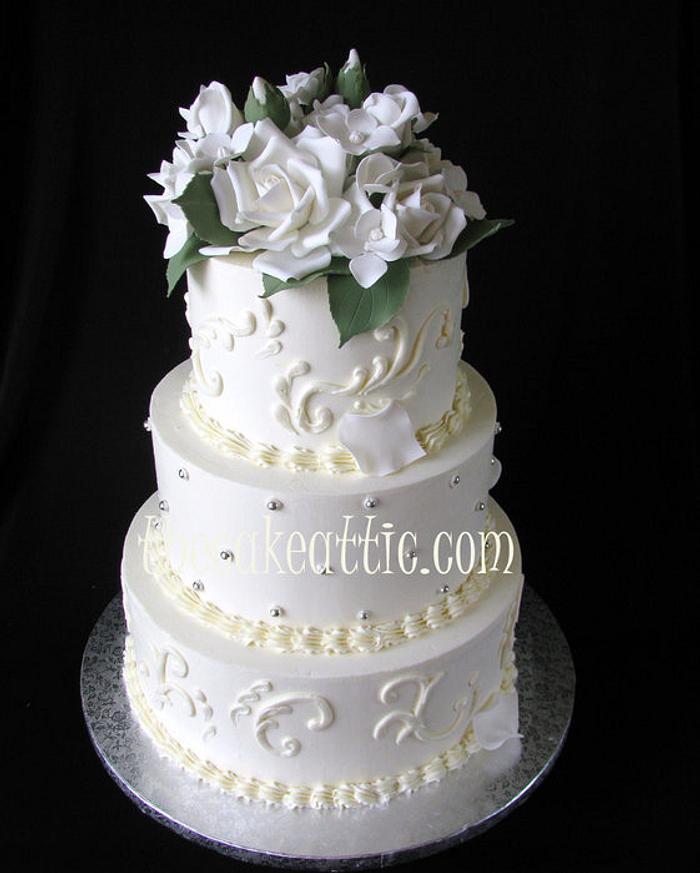 Buttercream wedding cake with scroll work and sugar roses 