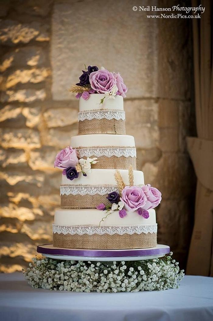 Hessian, lace and rose wedding cake and accompanying bride and groom topper 