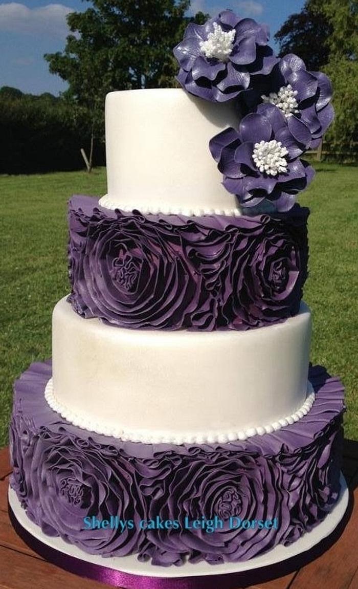 Purple and white ruffel rose wedding cake 
