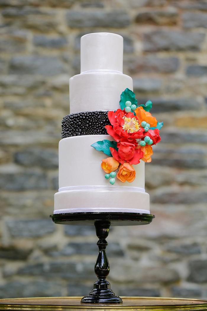 Bold flowers and foliage wedding cake.