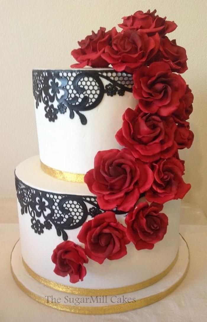 black and white wedding cake with red sugar roses