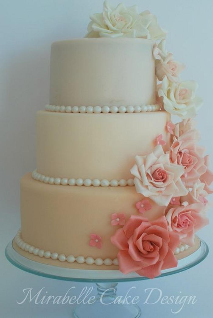 3 Tier Wedding cake in shades of pink with cascading roses