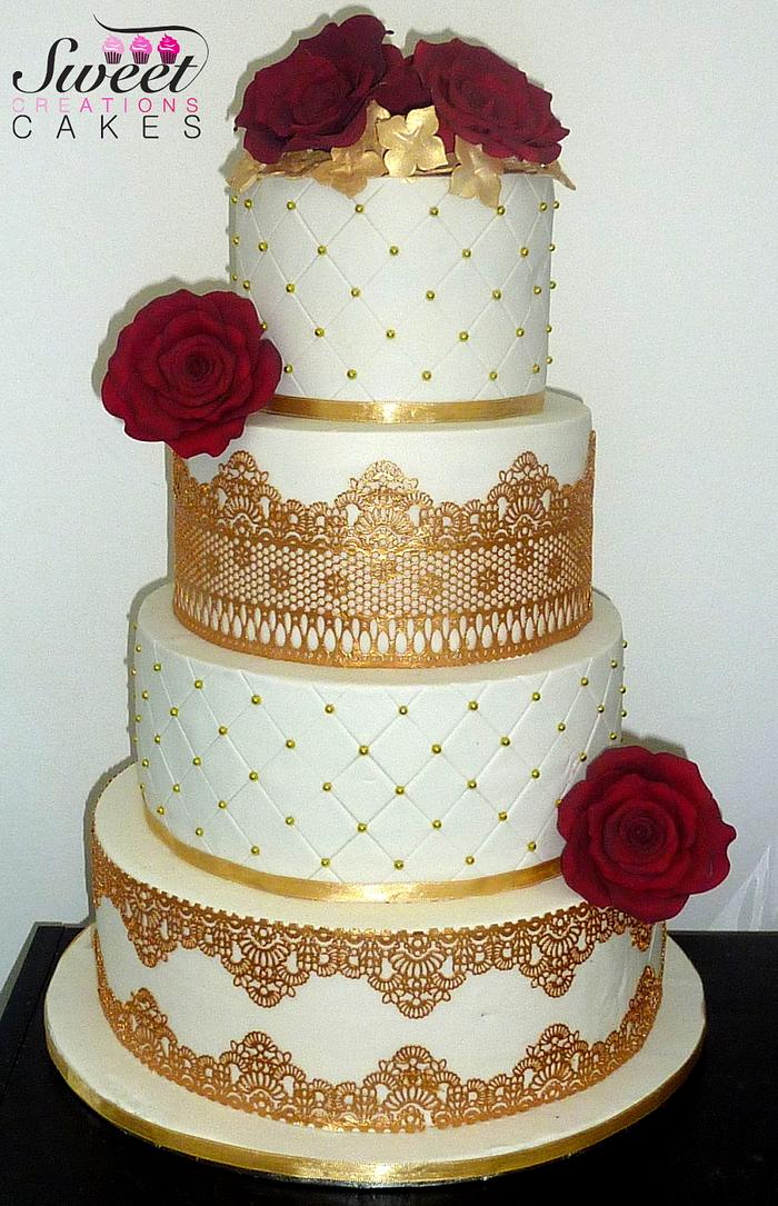 Gold wedding cake with red sugar roses 