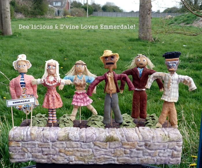Emmerdale Scarecrows looking after a mud cake (of course!)