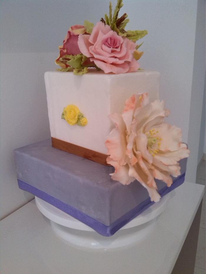 square pale mauve and white cake with flowers