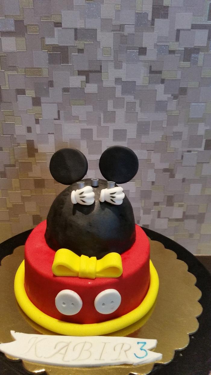 Mickey cake with matching cupcakes.