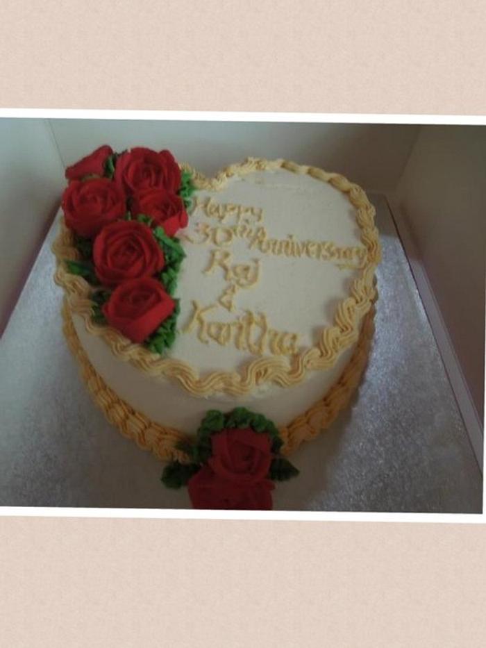 Heart shaped cake decorated with buttercream roses