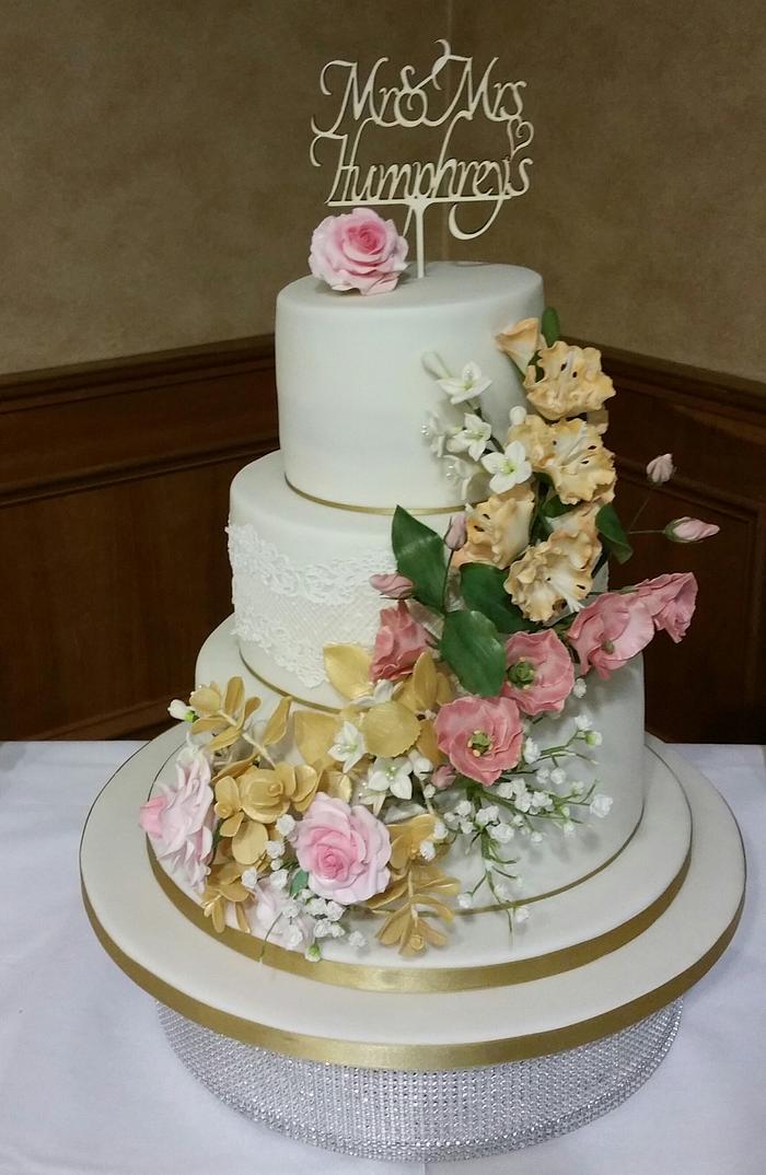 Wedding cake with Roses Lisianthus and Gladioli .