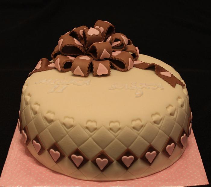 Cake with ribbon and small hearts