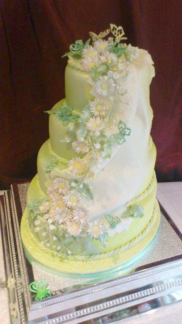 daisies and lilies of the valley cascade wedding cake 