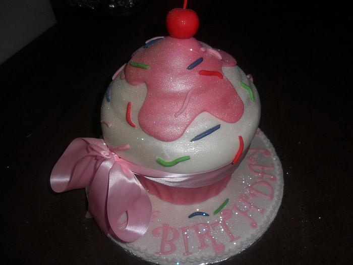 large giant pink white with a cherry on the top cupcake