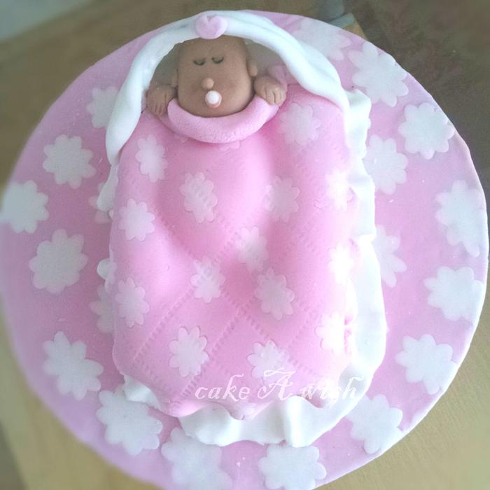 baby in a cradle cake