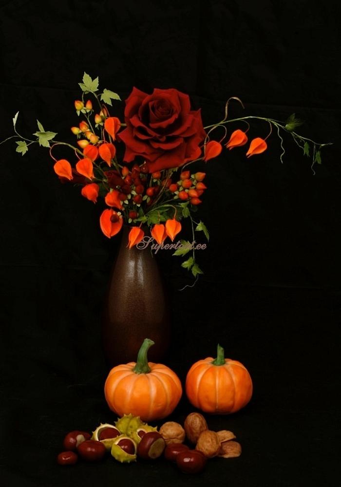 Autumn sugar flowers, pumpkins and nuts composition