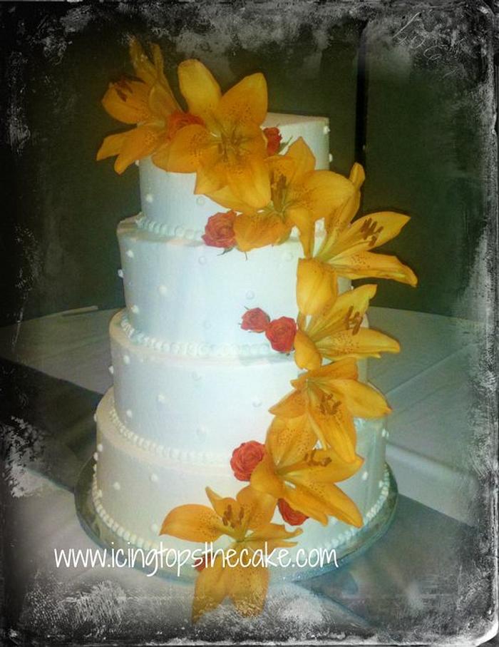 Simple 4 Tier Wedding Cake with Lillies and Roses