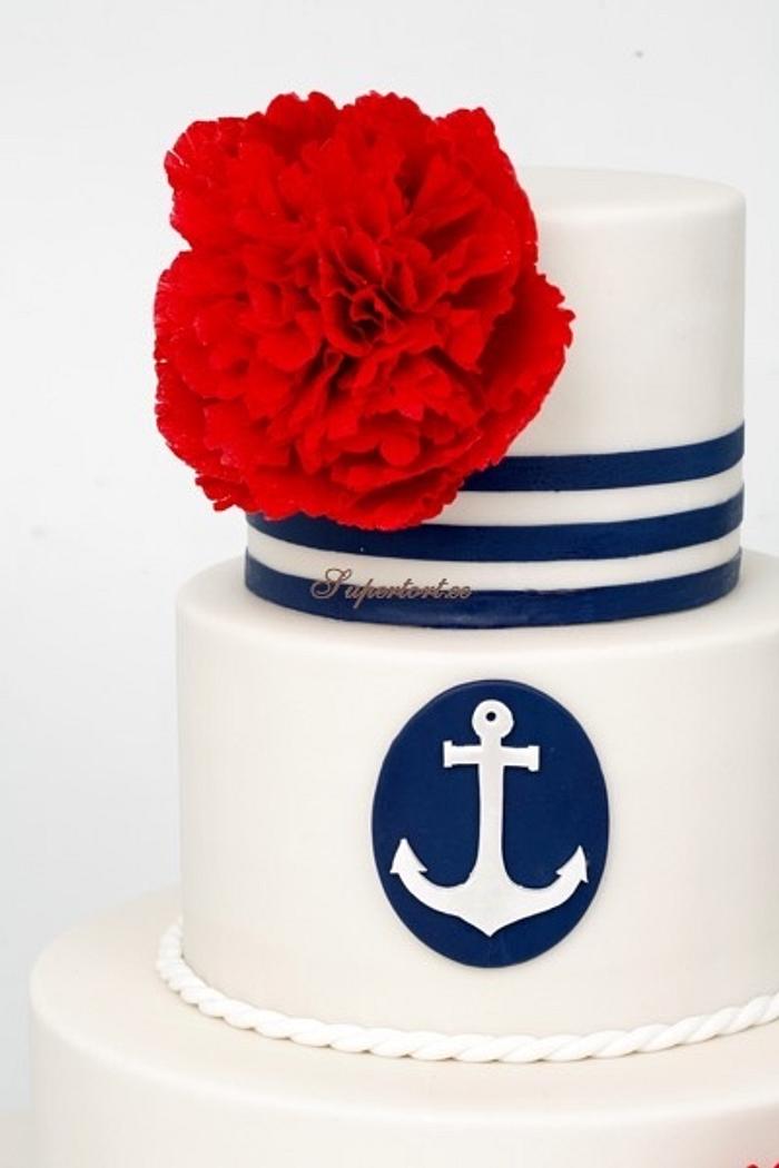 Navy themed wedding cake with red peonies