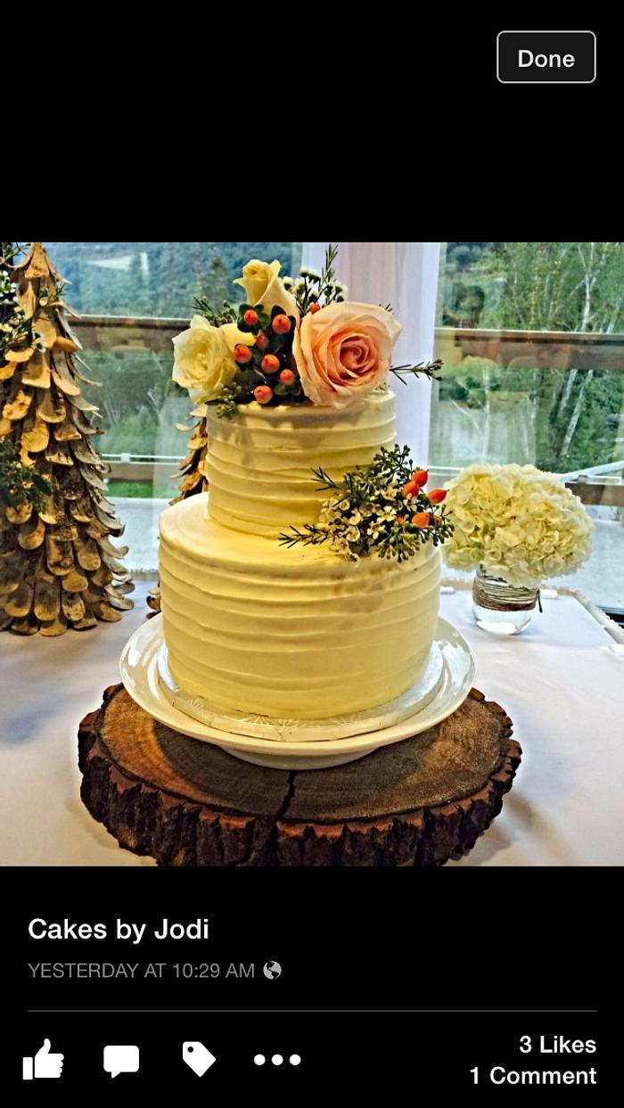 Rustic buttercream cake with fresh flowers