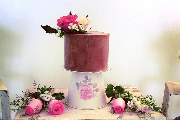 glossy ganache cake with fresh flowers