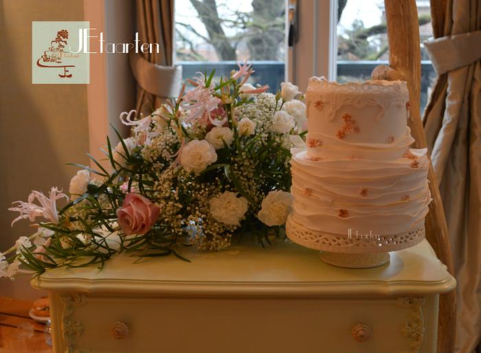 sweet weddingcake with lace, ruffles and little flowerdots