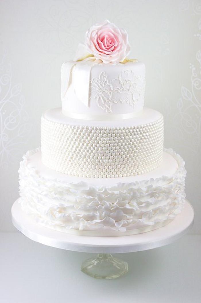 Blush pink ruffles, lace and rose wedding cake