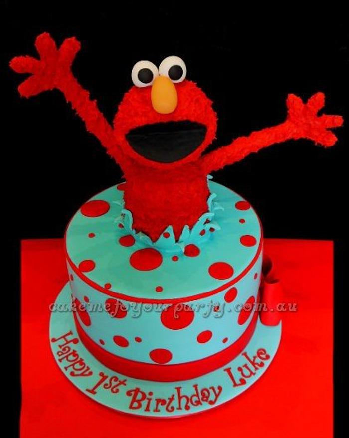 Elmo Jumping Out Of The Cake