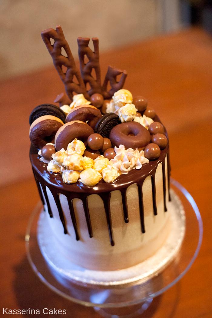 Caramel and chocolate candy cake with chocolate drip