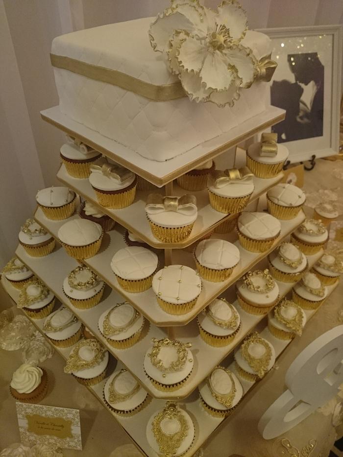 White  & gold wedding cake and cupcakes 