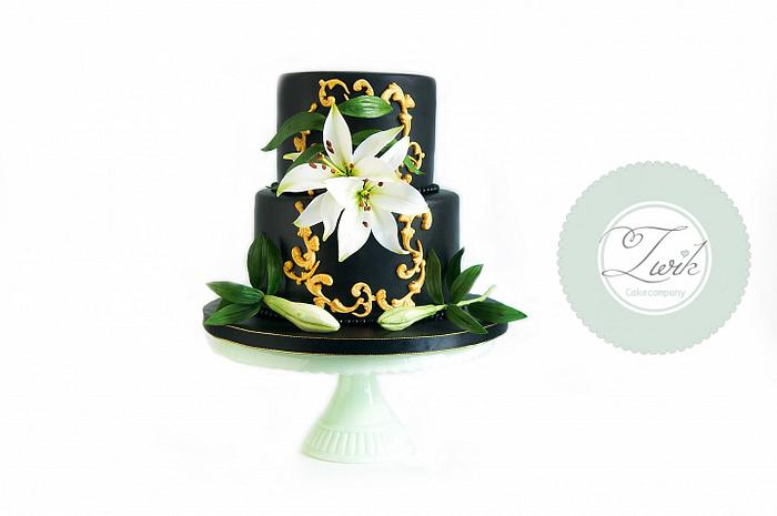 Black wedding cake with white lily