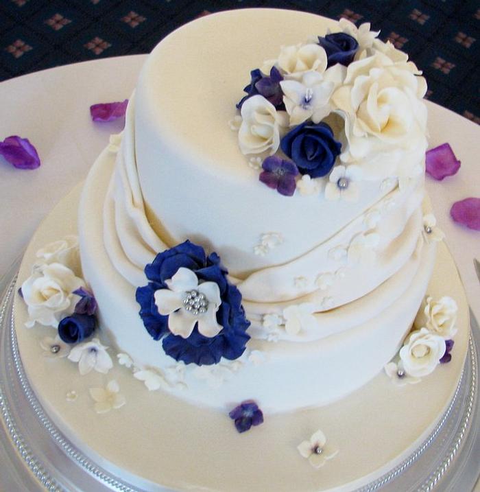 Sumptuous cream and cadbury purple wedding cake