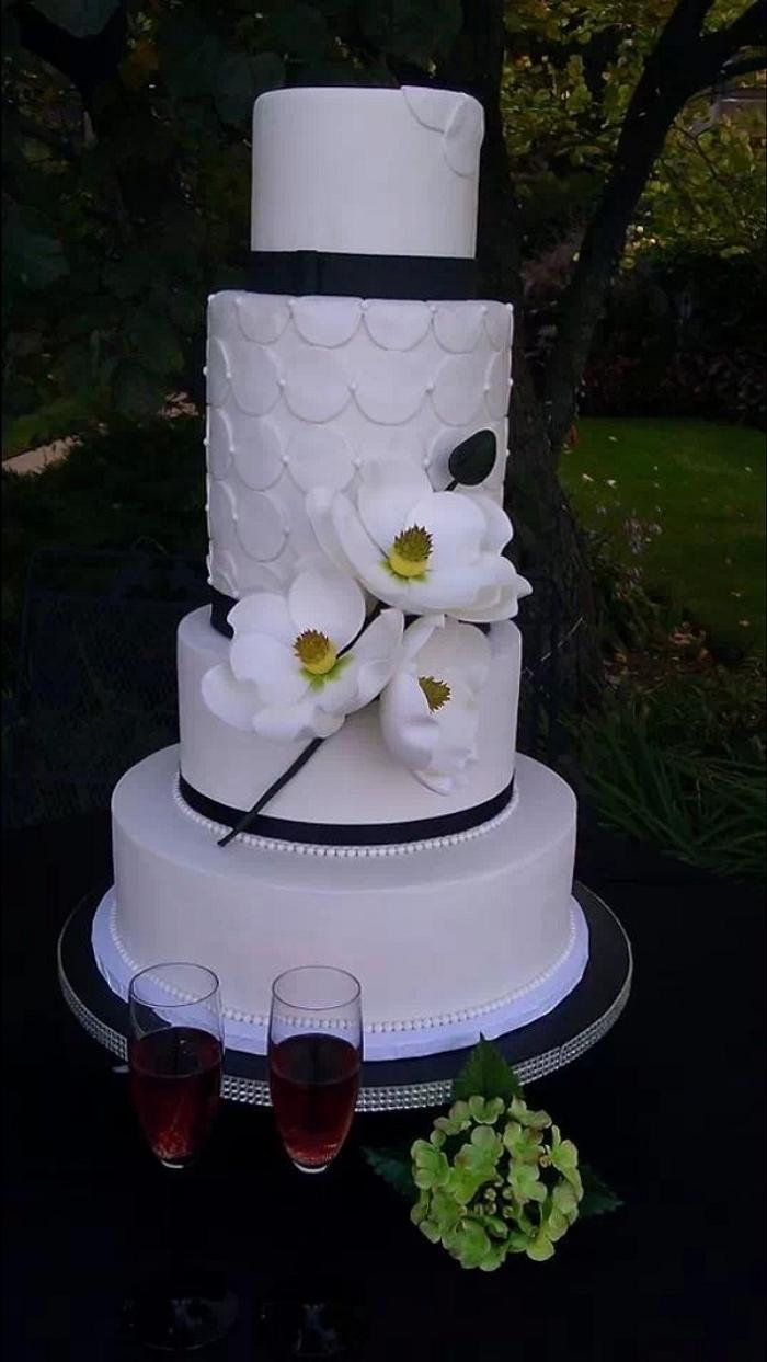 White wedding cake with sugar magnolias