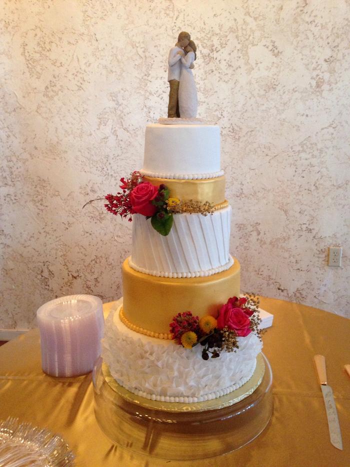 Gold and white wedding cake. 