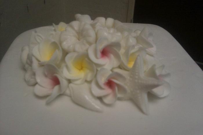 Frangipani and sea shell wedding cake