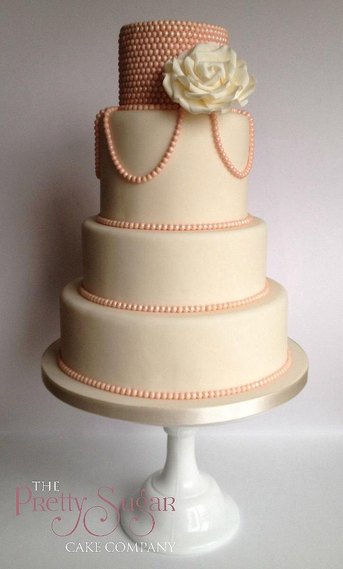 Twenties inspired blush pearl wedding cake