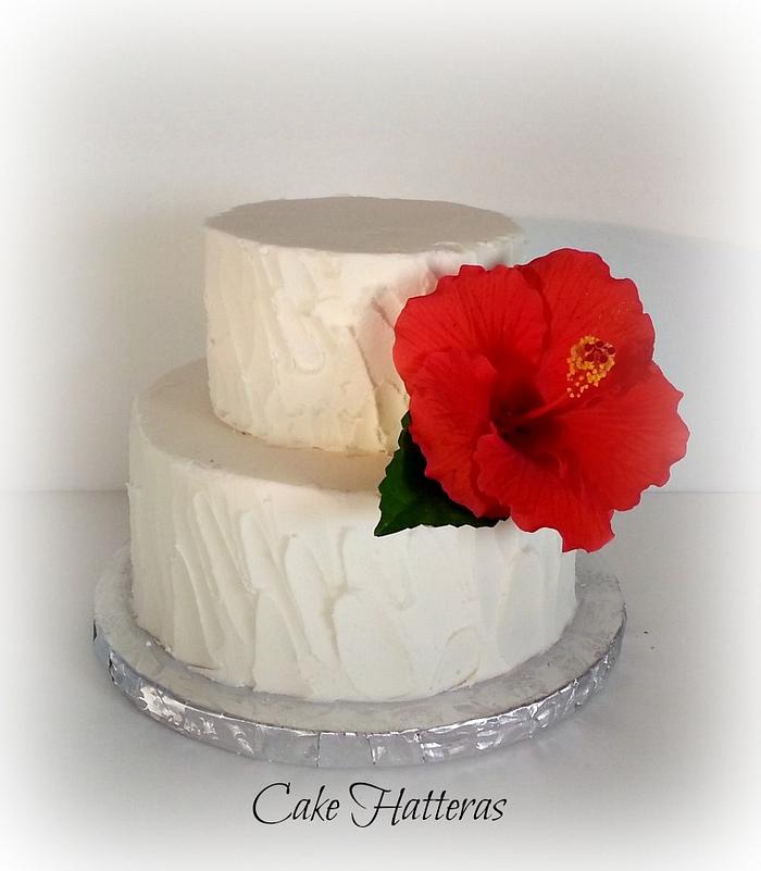 Rustic Iced Wedding Cake with fresh Hibiscus flower. 
