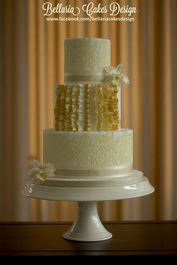 Ivory and gold wedding cake with edible lace and sugar Cattleya orchid