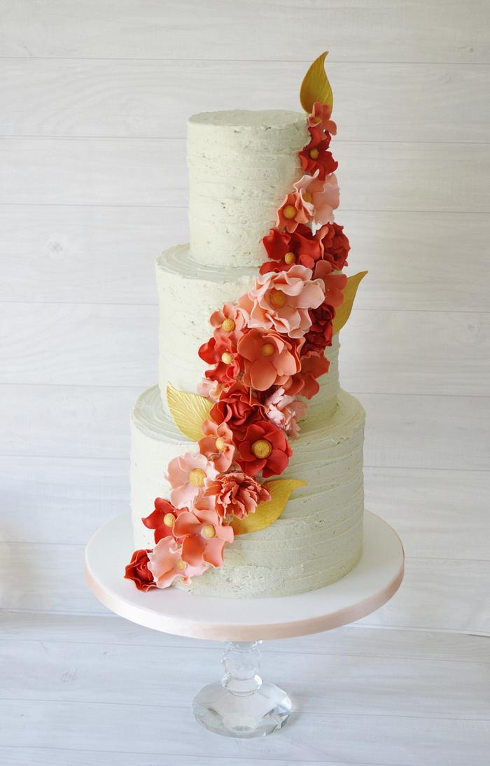 Pale Mint rustic buttercream with coral tone ruffle flowers