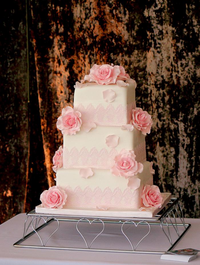 Pink roses and edible lace wedding cake