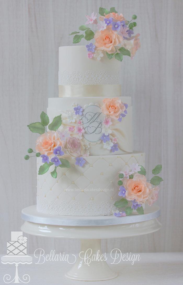 Ivory wedding cake with pastel flowers