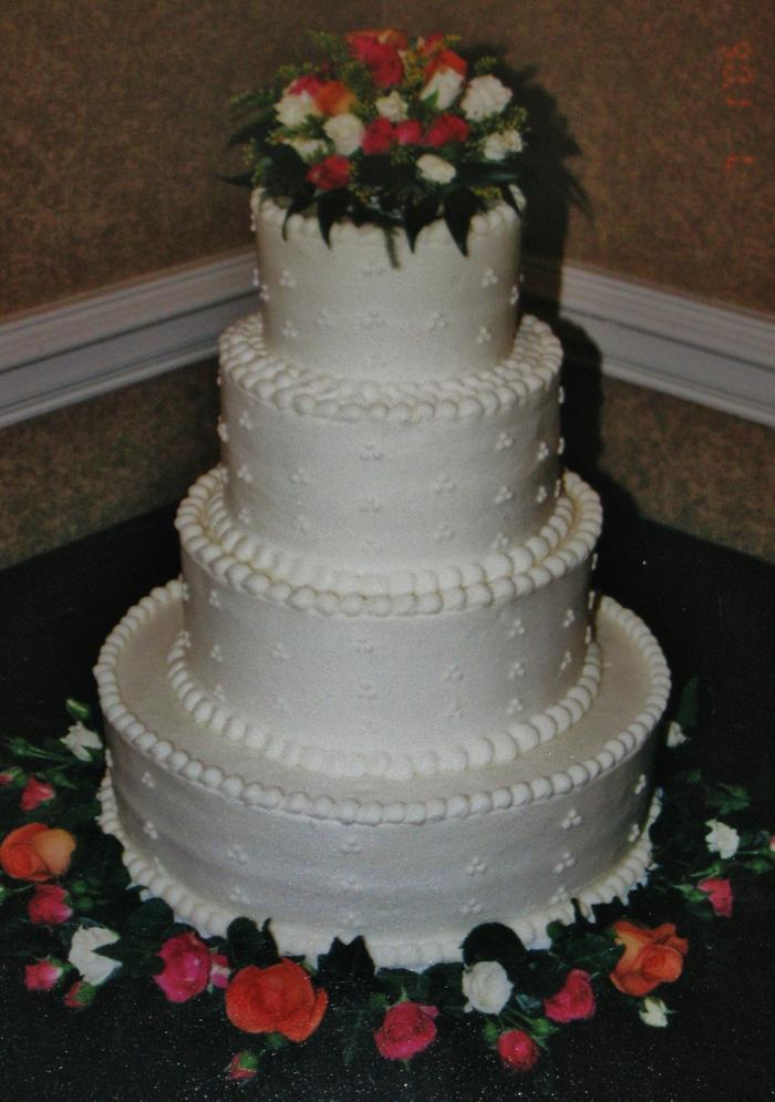 Buttercream orange, pink, and white wedding cake