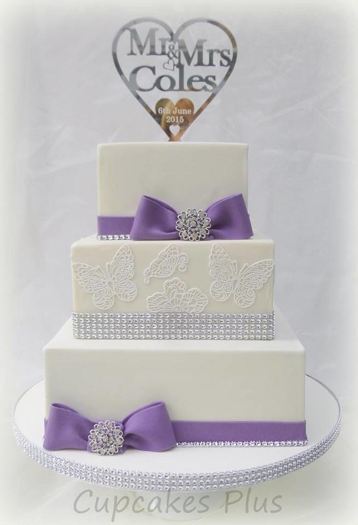 Purple bows, diamante and butterflies wedding cake