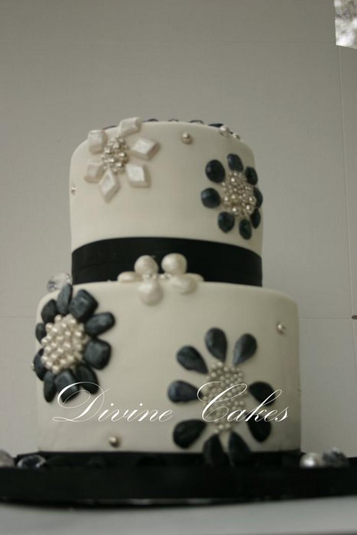 A 2 Tier Black andwhite Bejewled Cake..