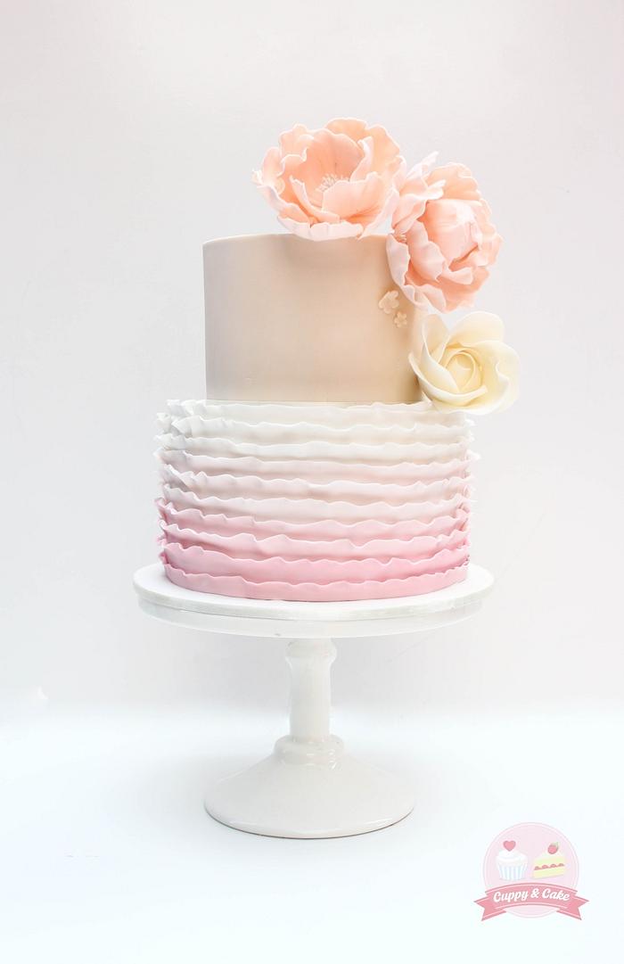 Pink ombre ruffle and flower cake