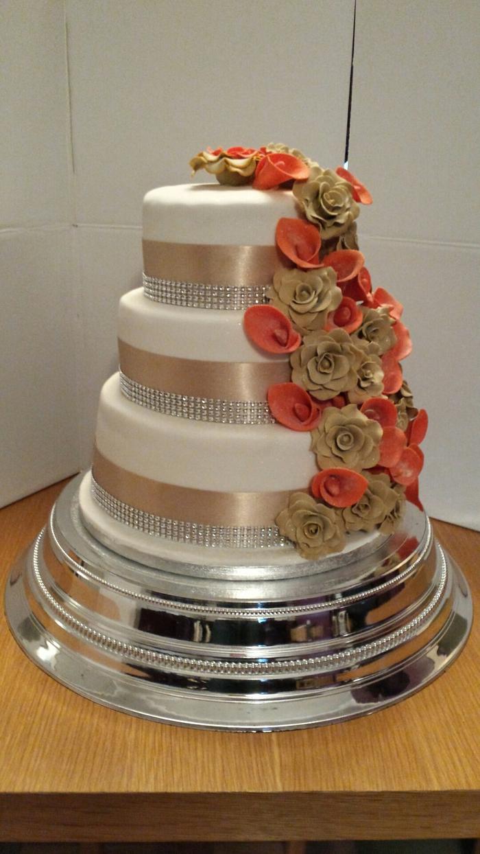 Autumn champaign rose and orange lilly wedding cake 