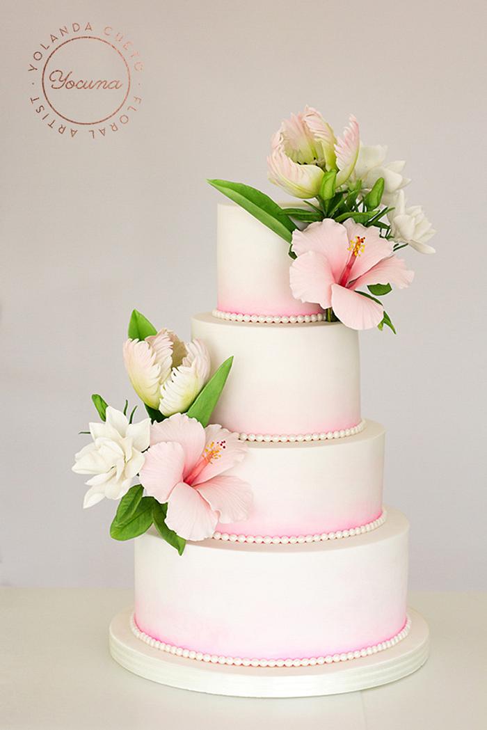 Wedding cake with tulips, hibiscus and anemones