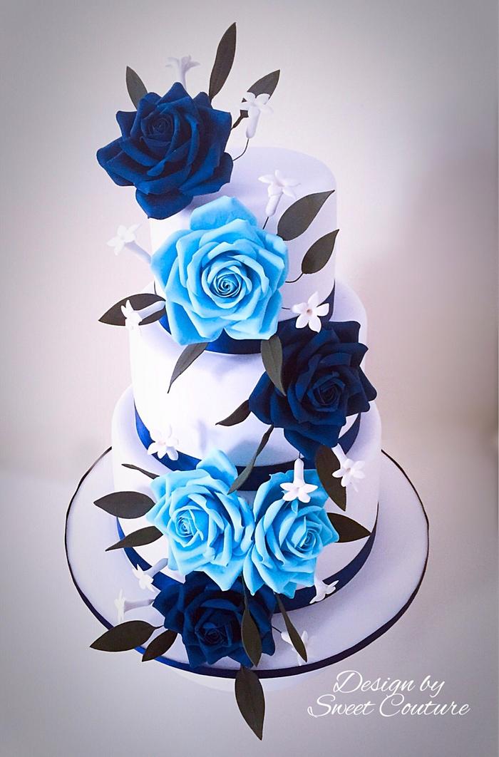 Blue roses themed wedding cake.